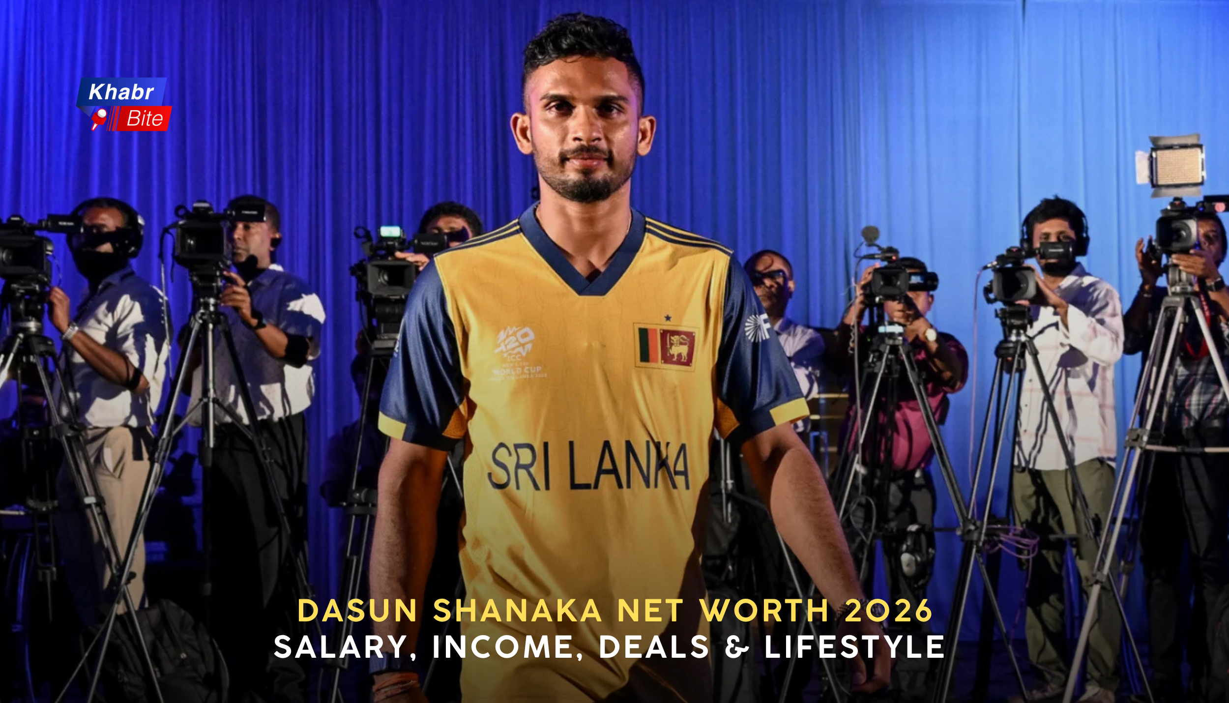 Sri Lankan cricketer Dasun Shanaka wearing a yellow Sri Lanka jersey stands in front of cameras and photographers during a media event,