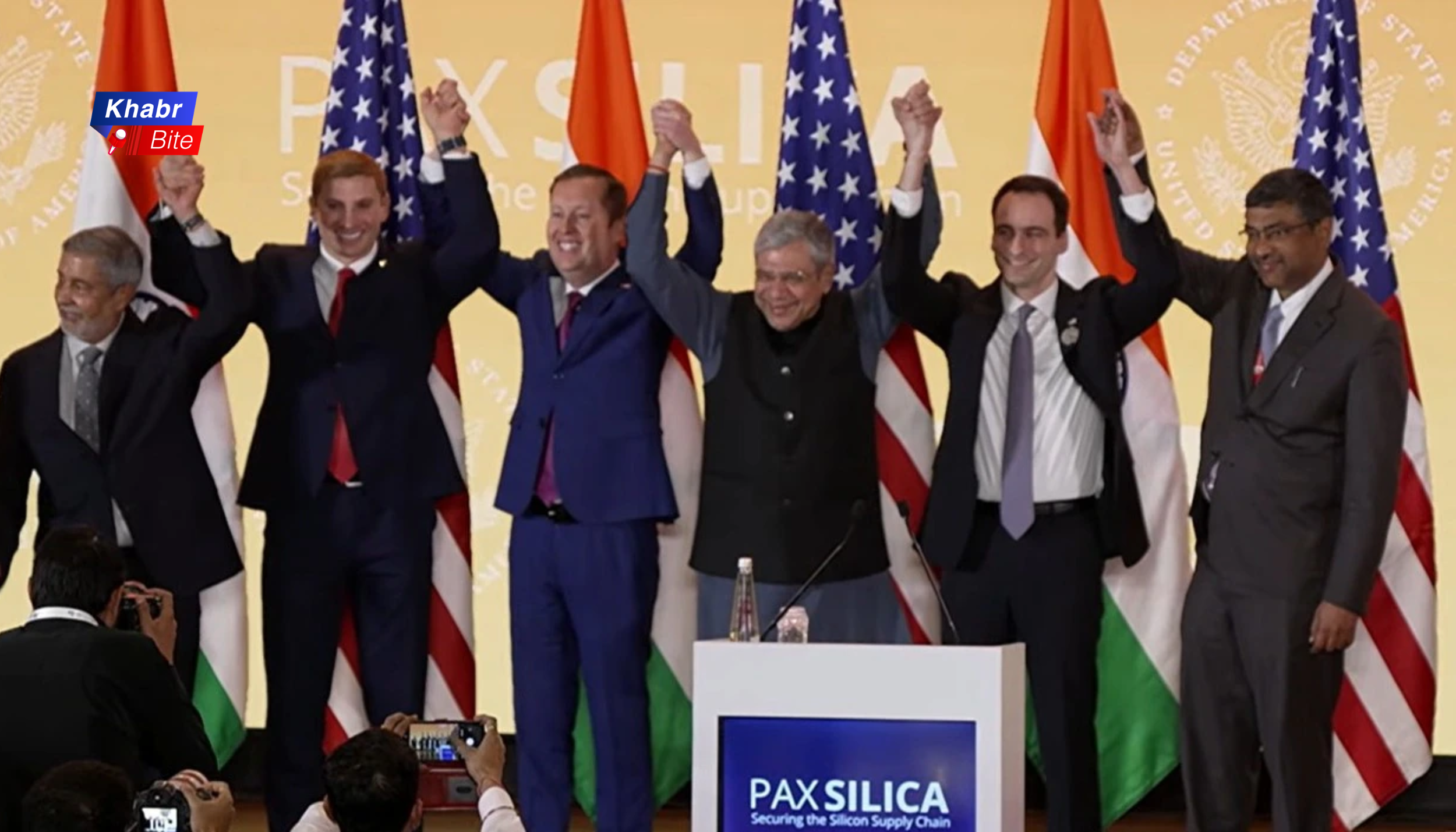 India US Pax Silica deal officials raising hands at tech partnership event