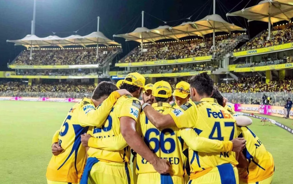 Chennai Super Kings players celebrating together during an IPL match.