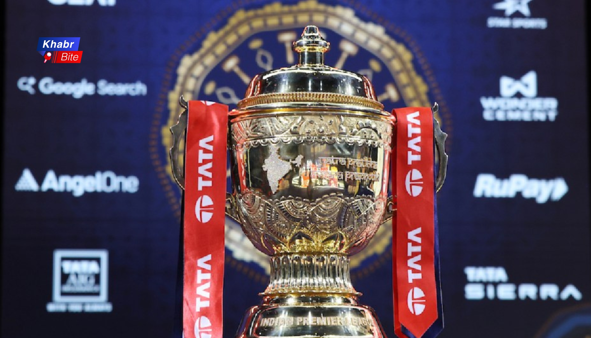 TATA IPL trophy with red ribbons and sponsor backdrop