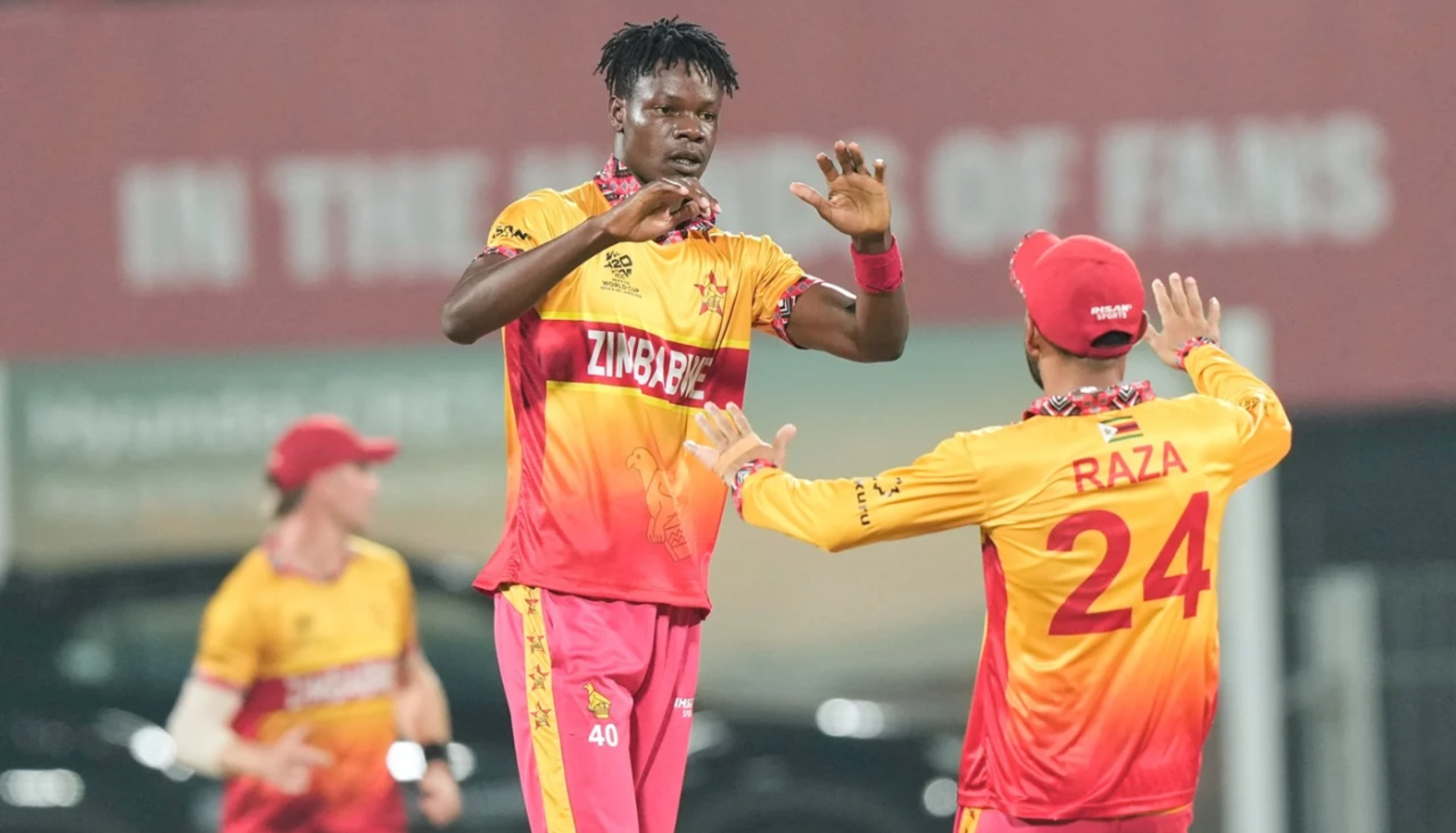 Blessing Muzarabani celebrates a wicket with Sikandar Raza while playing for Zimbabwe in an international T20 match