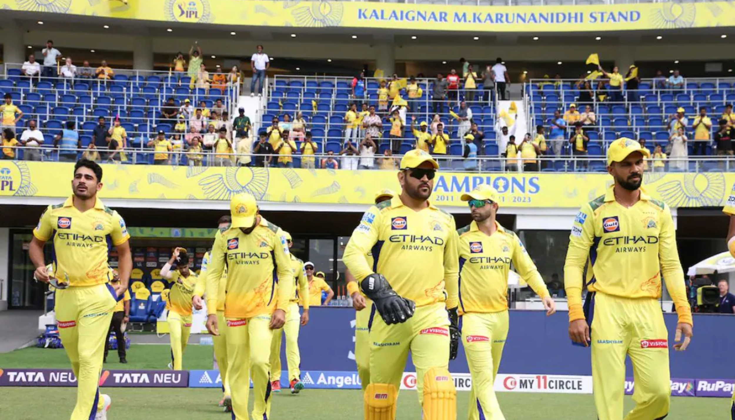 Chennai Super Kings players walking onto the field during an IPL match
