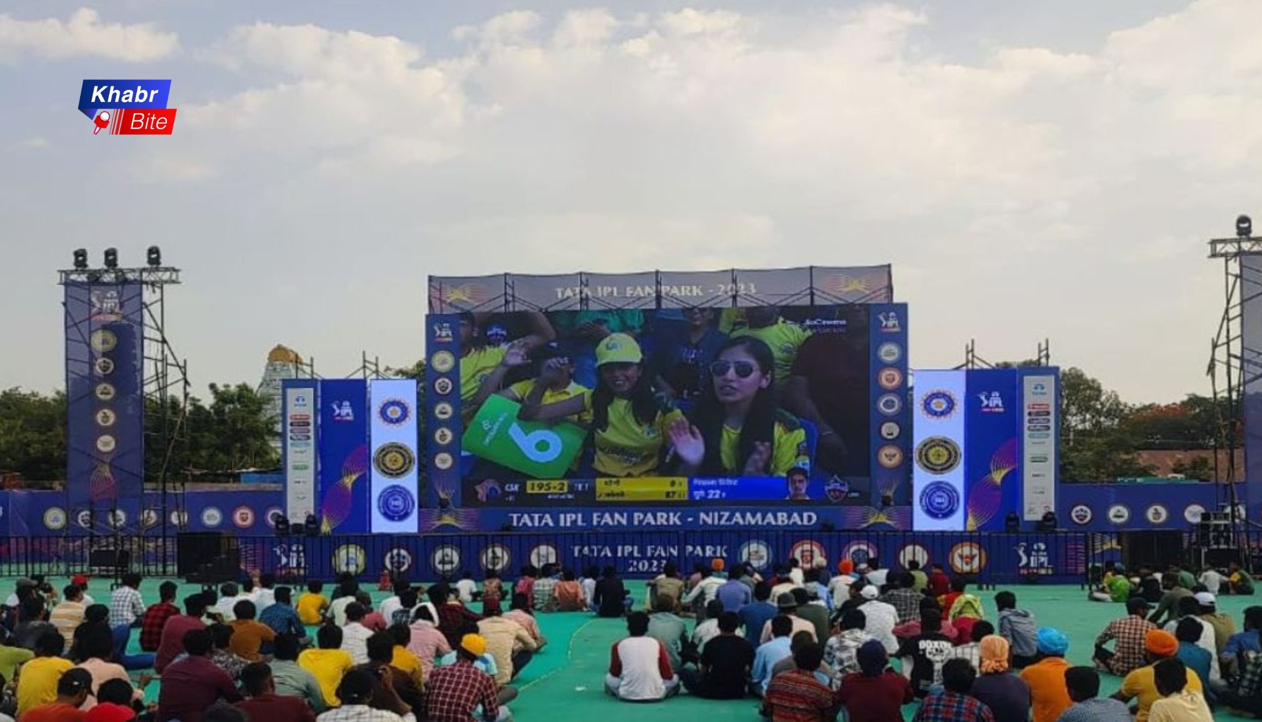 IPL fan park event with large crowd watching live cricket match on giant screen outdoors