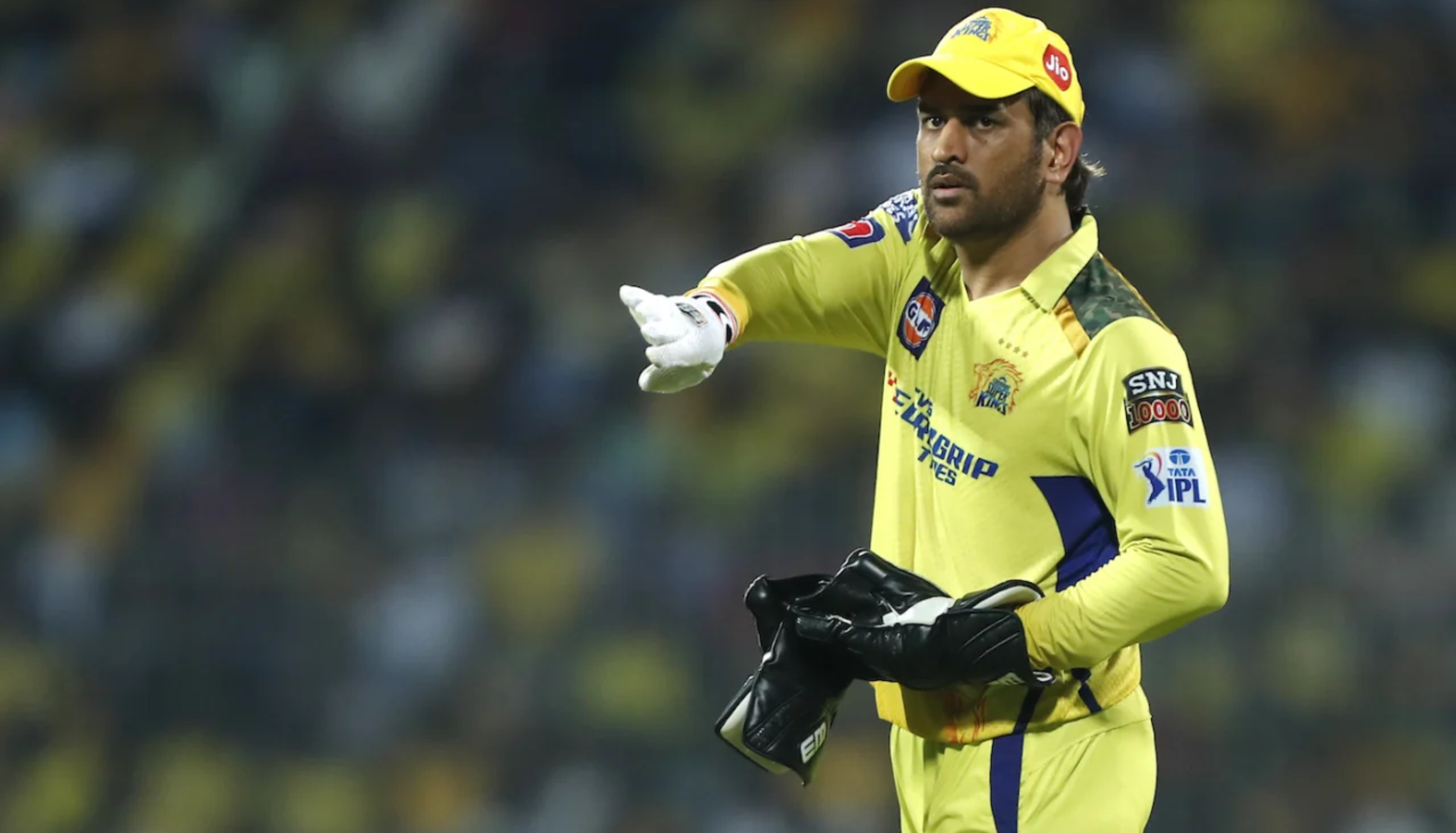 Chennai Super Kings wicketkeeper-batsman in yellow jersey during an IPL match giving instructions to teammates