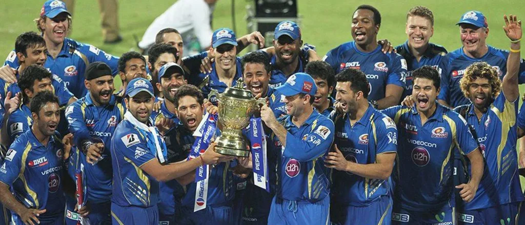 Mumbai Indians players celebrate with the IPL trophy after title win